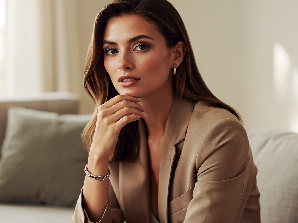 Woman in a beige blazer sitting on a couch in a well-lit room