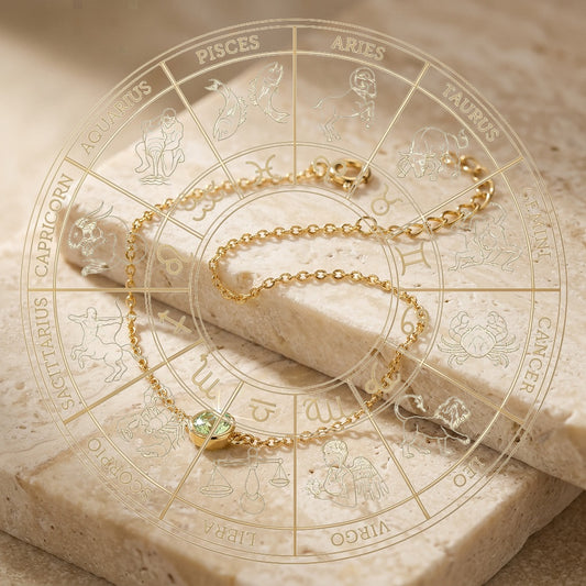 Gold bracelet with a green gemstone on an astrological chart