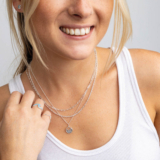 Layered sterling silver necklaces on model, minimal stacked jewellery styling