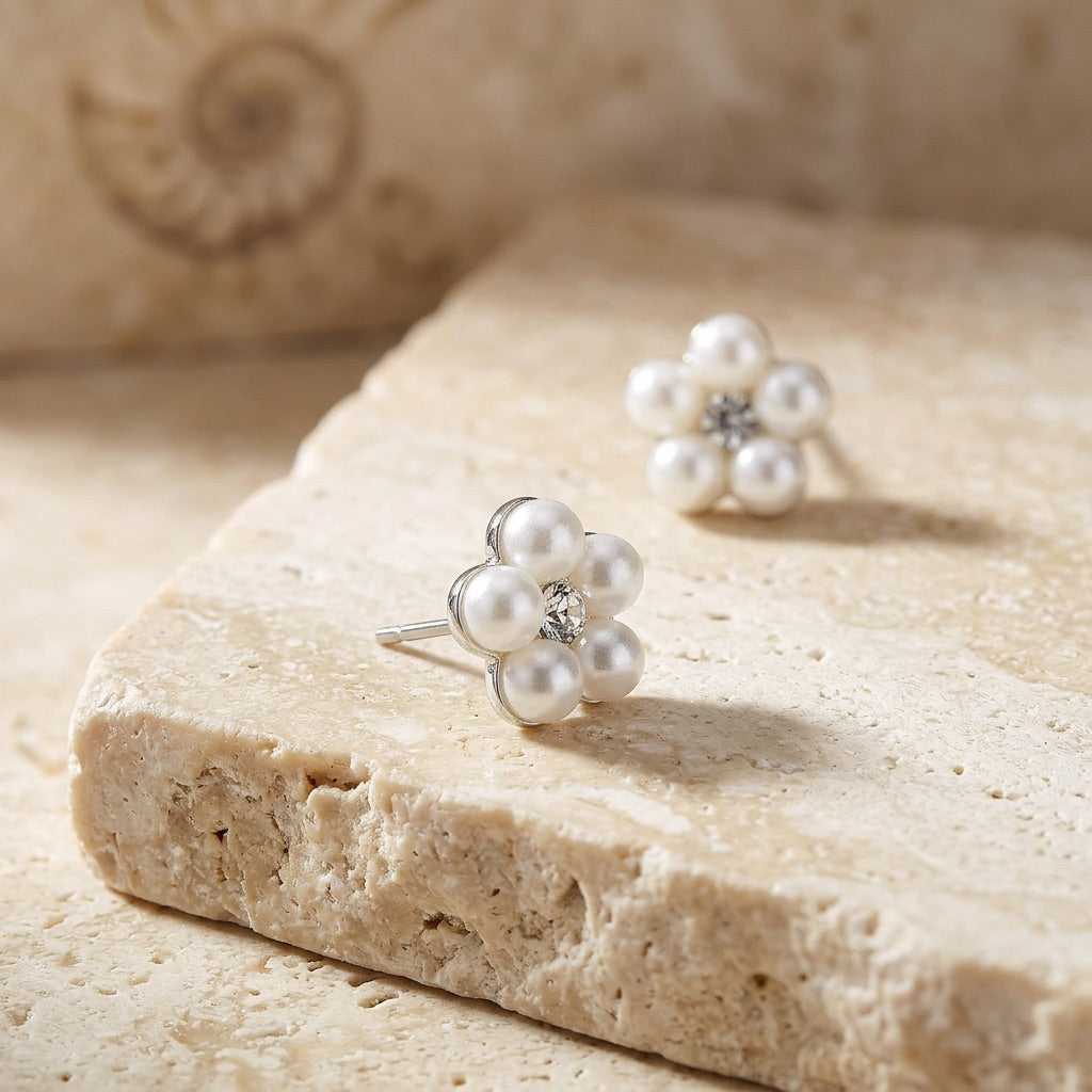 Pearl earrings on a textured stone surface