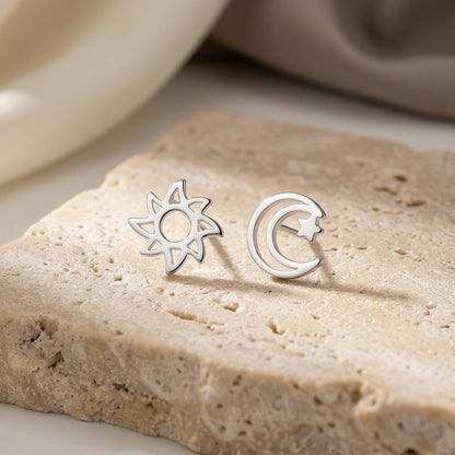 D4359SE - Sun, Moon & Star Silver Stud Earrings on a beige stone surface