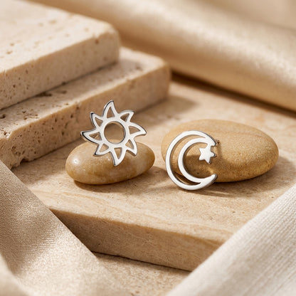 D4359SE - Sun, Moon & Star Silver Stud Earrings on stones with a natural stone background