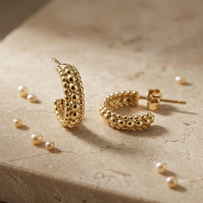 Gold Plate 13mm Triple Beaded Stud Hoop Earrings on a textured beige surface with scattered pearls.
