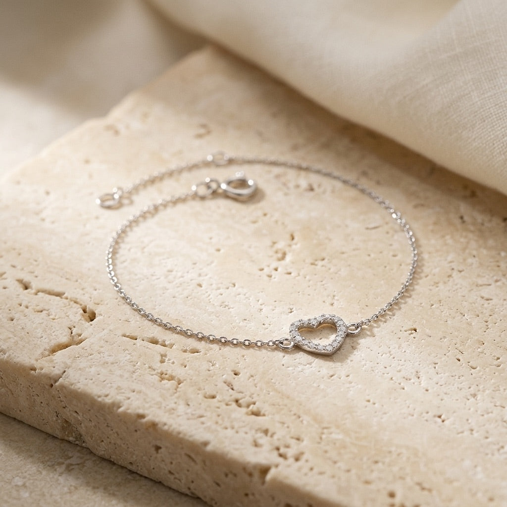 Open Heart Cubic Zirconia Bracelet on a beige stone surface