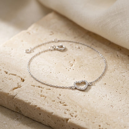 Open Heart Cubic Zirconia Bracelet on a beige stone surface