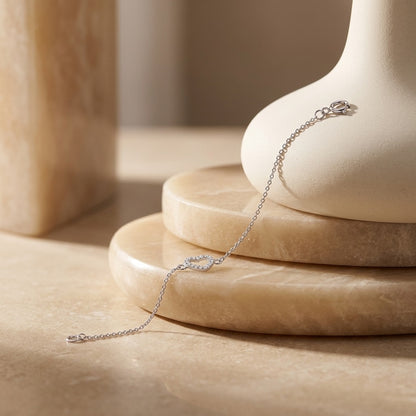 Open Heart Cubic Zirconia Bracelet on a beige stone surface