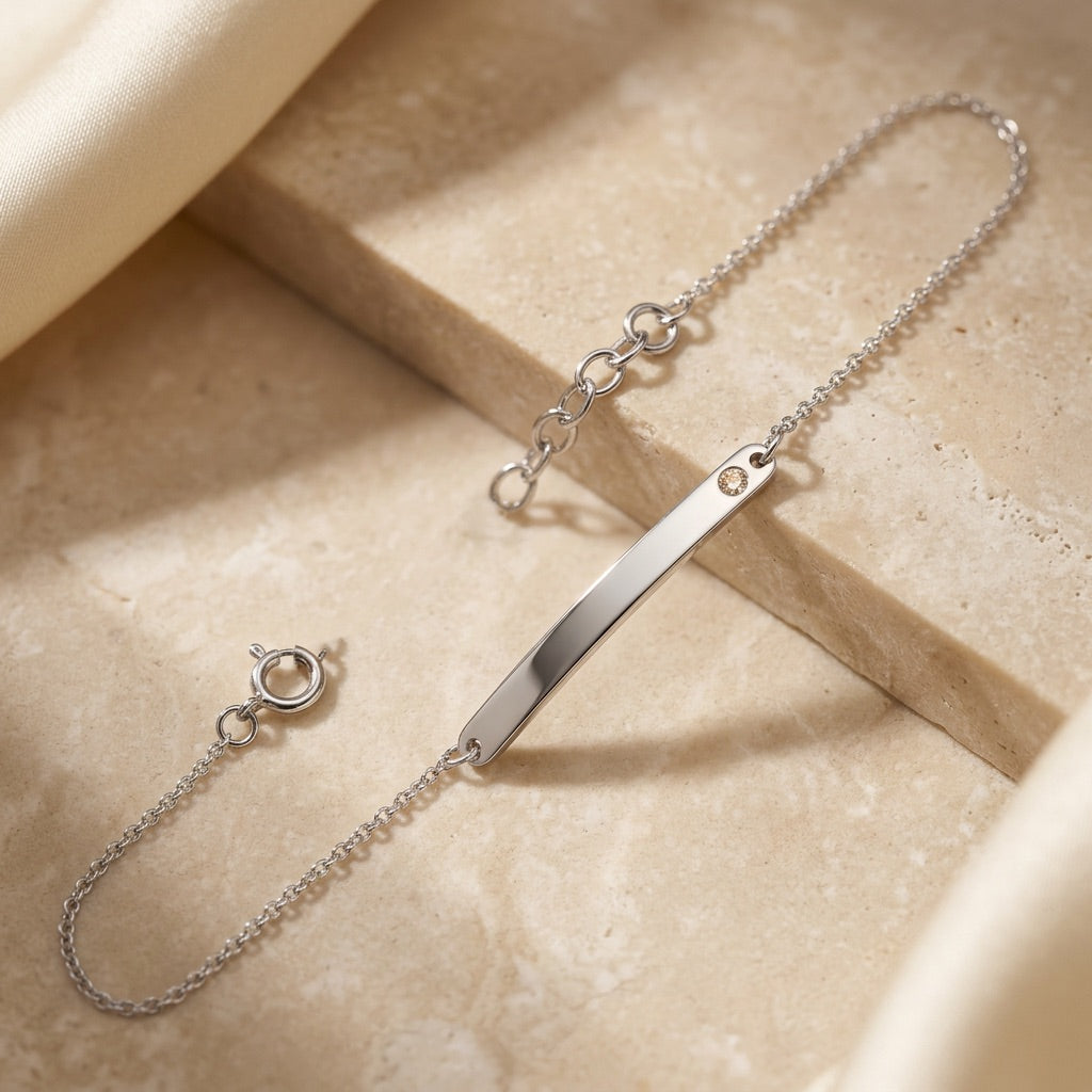 Classic ID Tag with Flush Set Cubic Zirconia 7” Bracelet on a beige surface