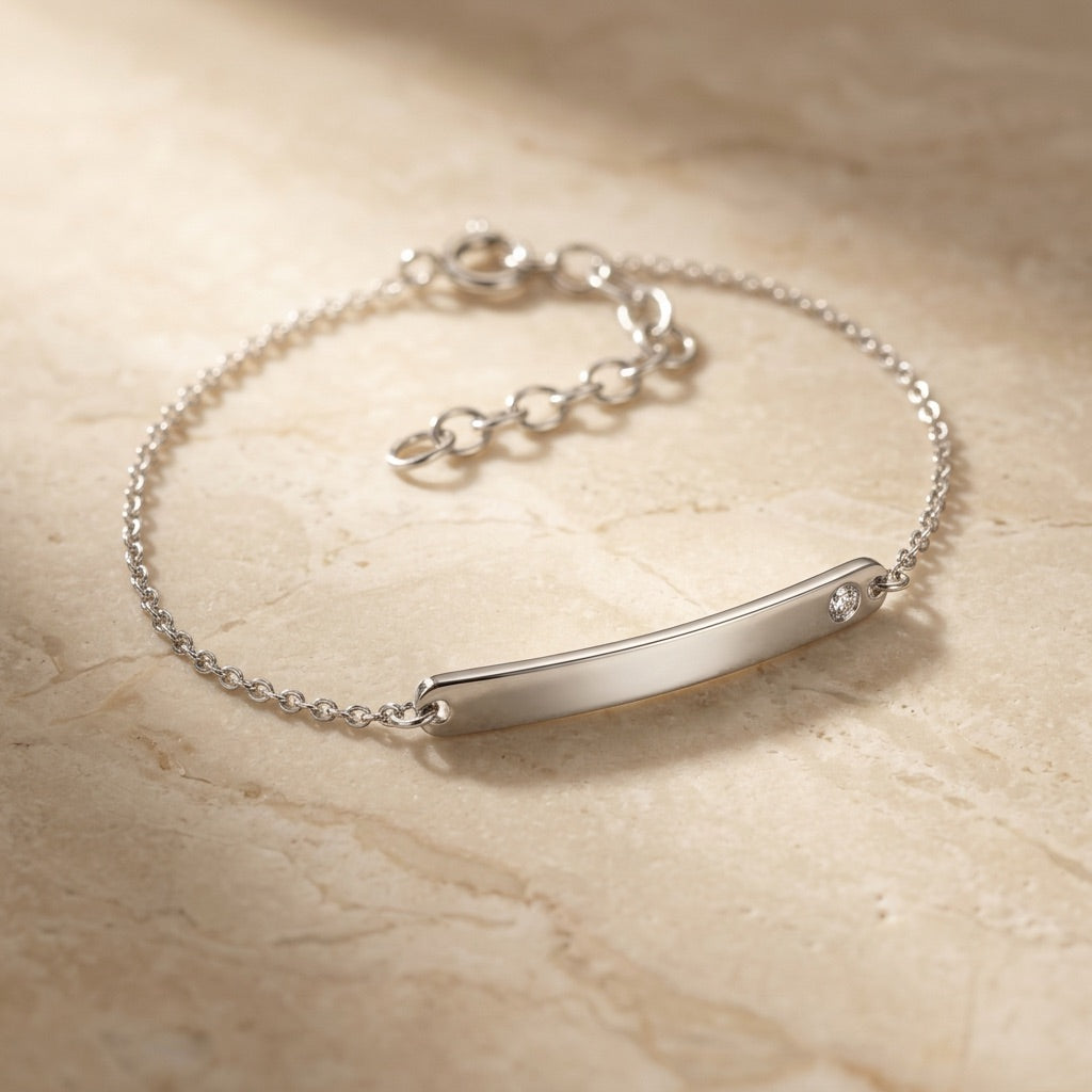 Classic ID Tag with Flush Set Cubic Zirconia 7” Bracelet on a beige marble surface