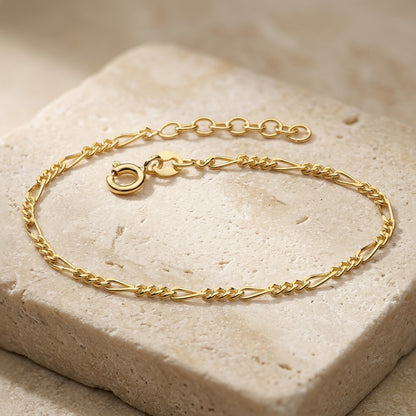 Golden Figaro Gold Plate Bracelet on a textured beige surface
