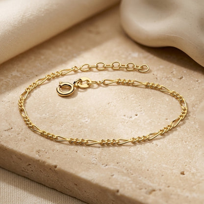 Golden Figaro Gold Plate Bracelet on a beige stone surface