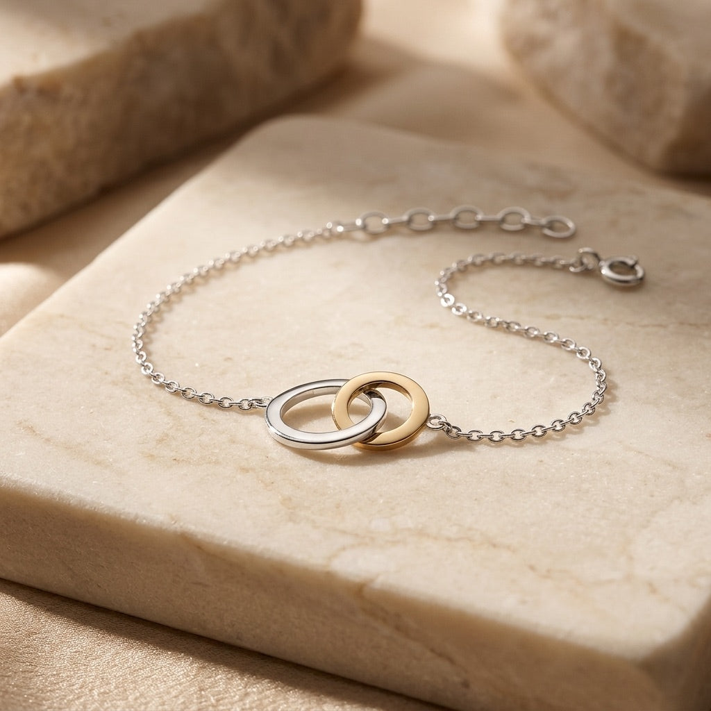 Bracelet with interlocking rings on a beige stone surface