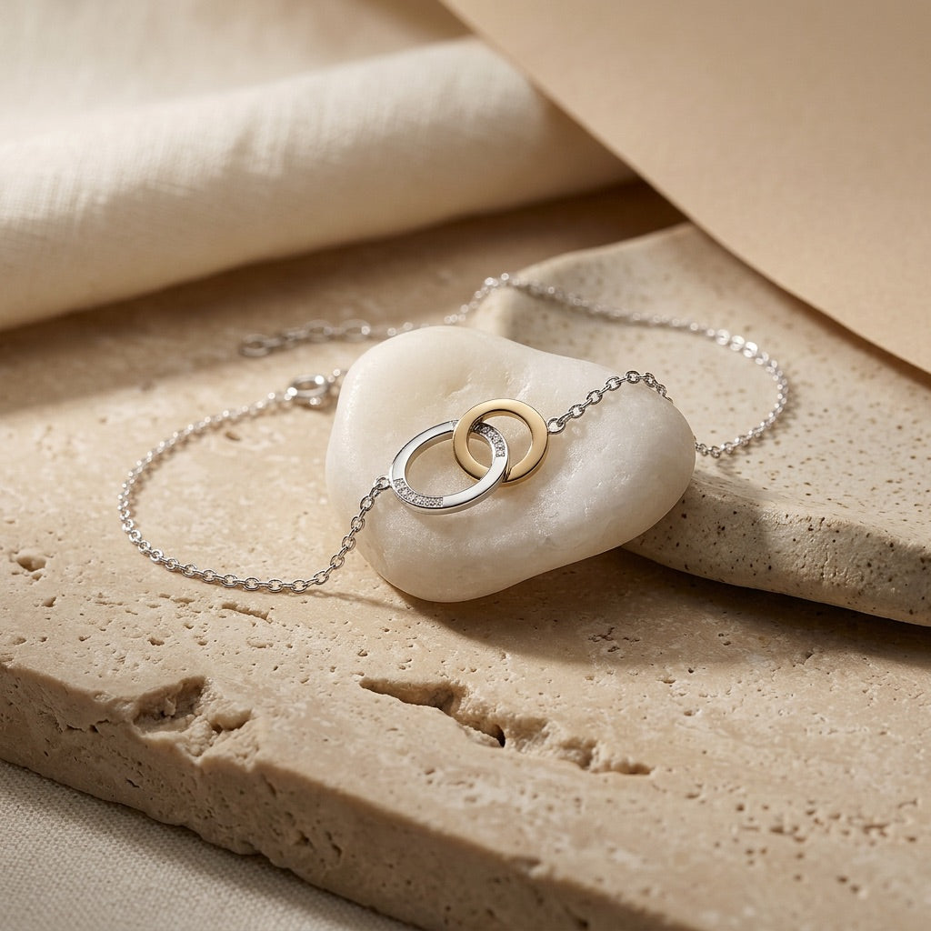 Linked Circle Gold Plate Bracelet on a stone surface