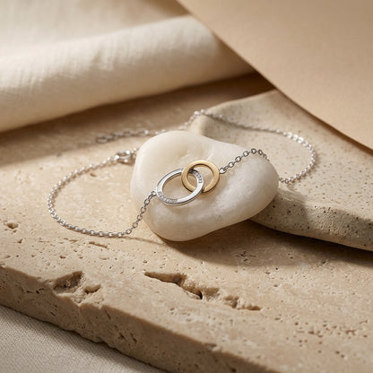 Linked Circle Gold Plate Bracelet on a stone surface
