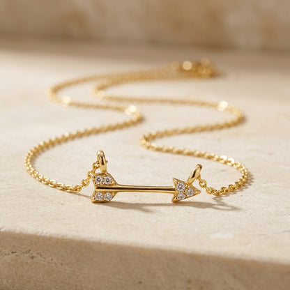 Golden Pavé Cubic Zirconia Arrow 18” Necklet on a beige surface