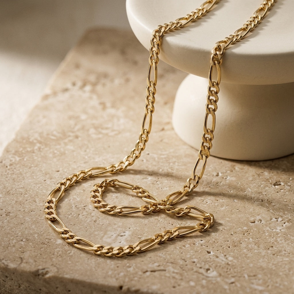 Golden Gold Plate Figaro Chain 18” Necklace on a textured surface with a neutral background