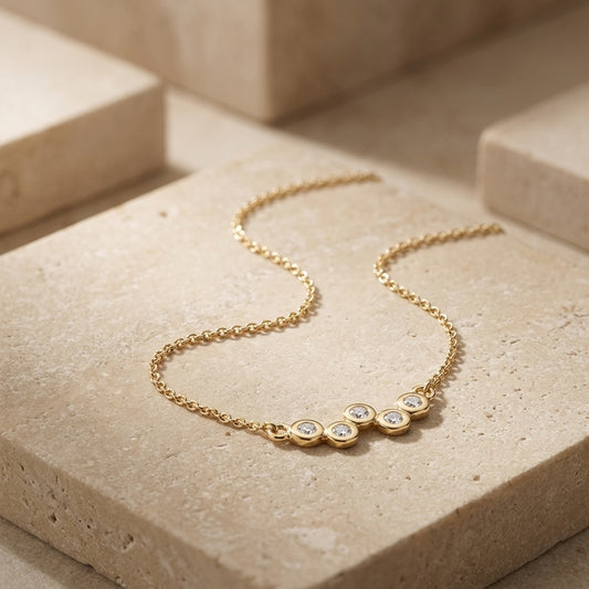 Golden Cubic Zirconia Gold Plate Scatter 18” Necklet on a beige stone surface