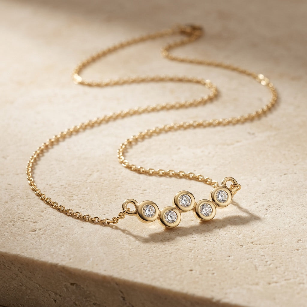 Golden Cubic Zirconia Gold Plate Scatter 18” Necklet on a beige surface