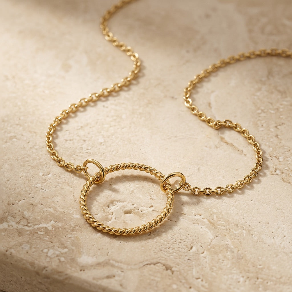Golden Open Circle Rope Twist 18” Necklet on a textured beige surface