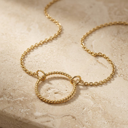 Golden Open Circle Rope Twist 18” Necklet on a textured beige surface
