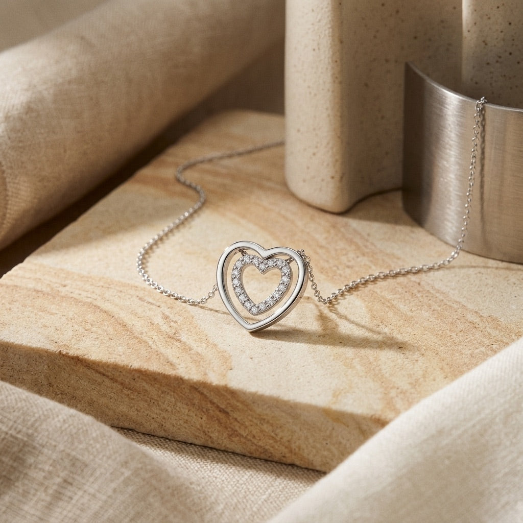 Cubic Zirconia Double Open Heart 18” Necklet  on a beige marble surface