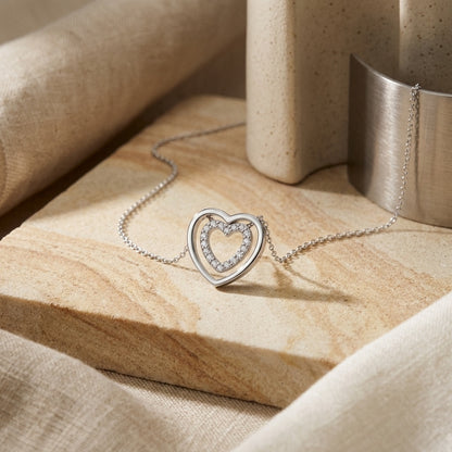 Cubic Zirconia Double Open Heart 18” Necklet  on a beige marble surface