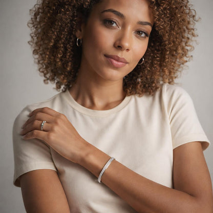 Woman wearing a plain white t-shirt. She is also wearing a bracelet, a "Square Channel Set Bangle with Cubic Zirconia". Image taken with a neutral background