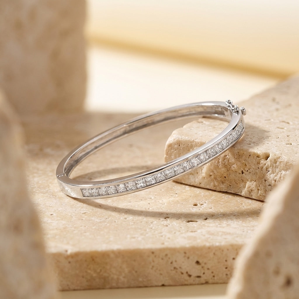Silver bracelet with small diamonds on a stone surface