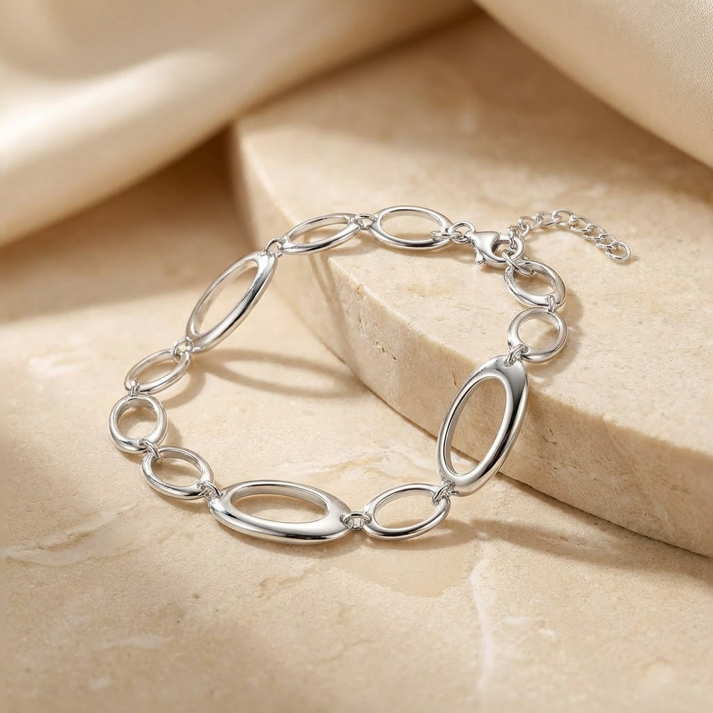 Silver bracelet on a beige stone surface