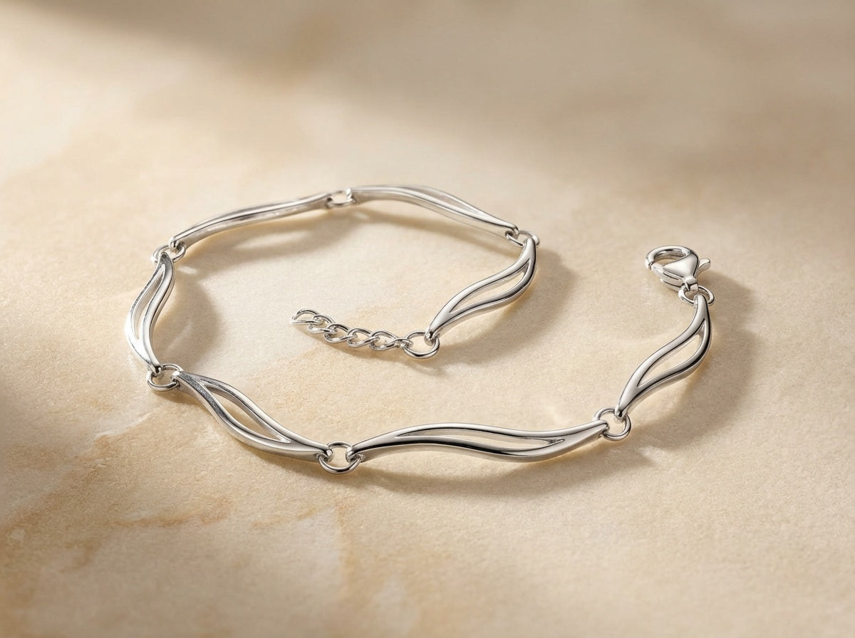 Close up - Silver bracelet on a beige stone surface