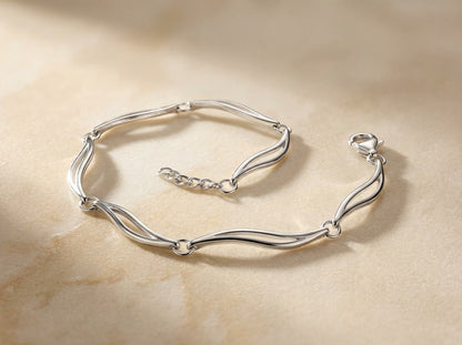 Close up - Silver bracelet on a beige stone surface
