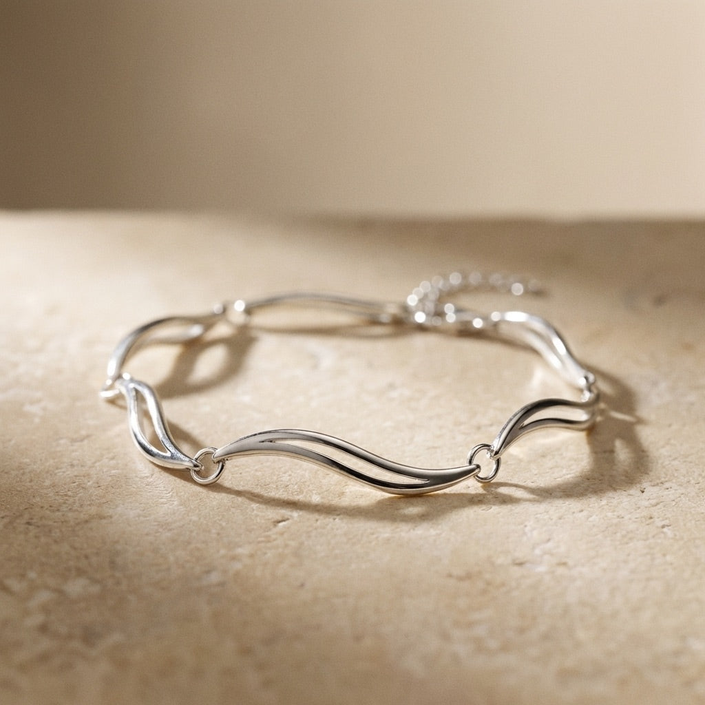 Silver bracelet on a beige surface