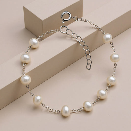 Pearl bracelet on a beige geometric background
