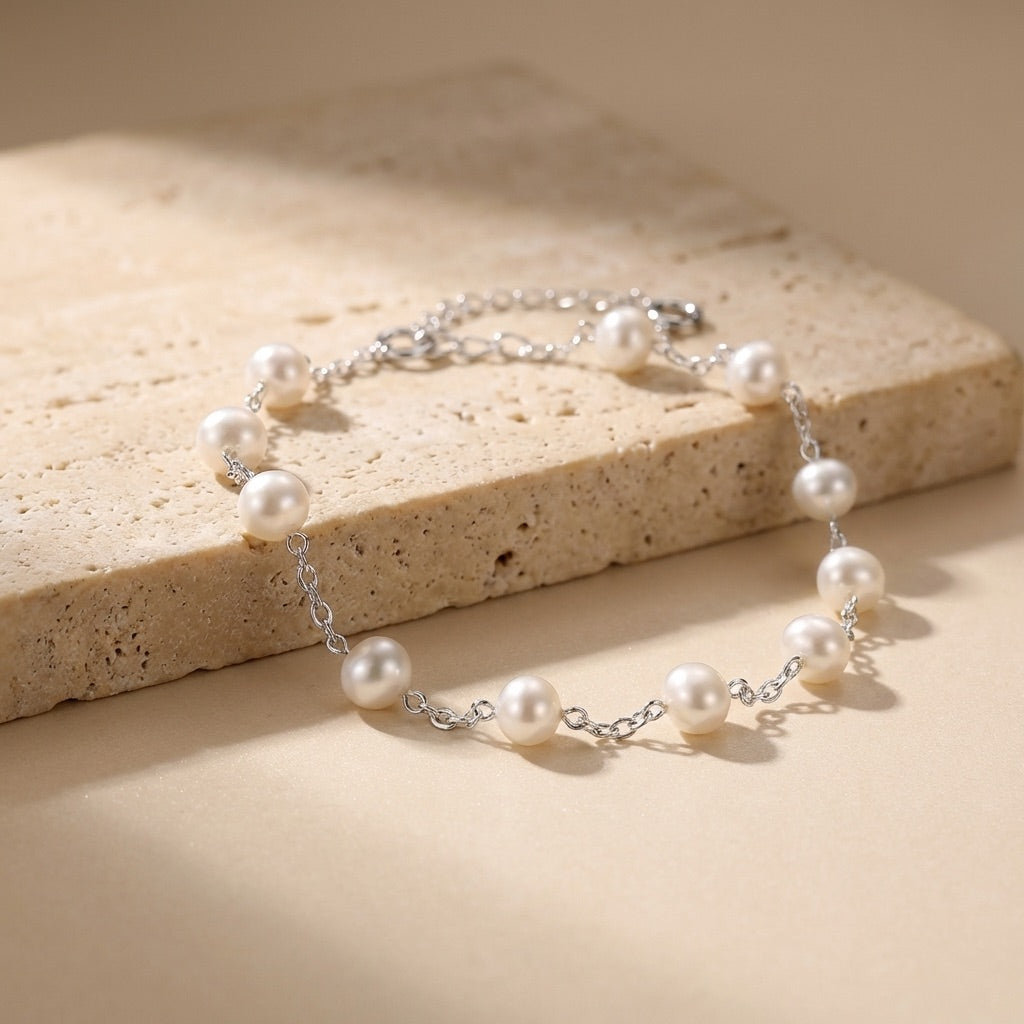 Pearl bracelet on a beige stone surface