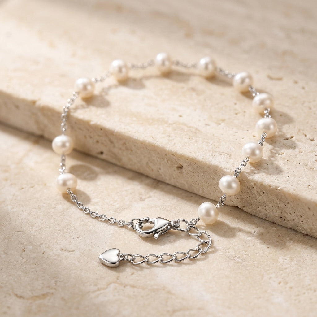 Pearl bracelet with silver clasp on a light wooden surface