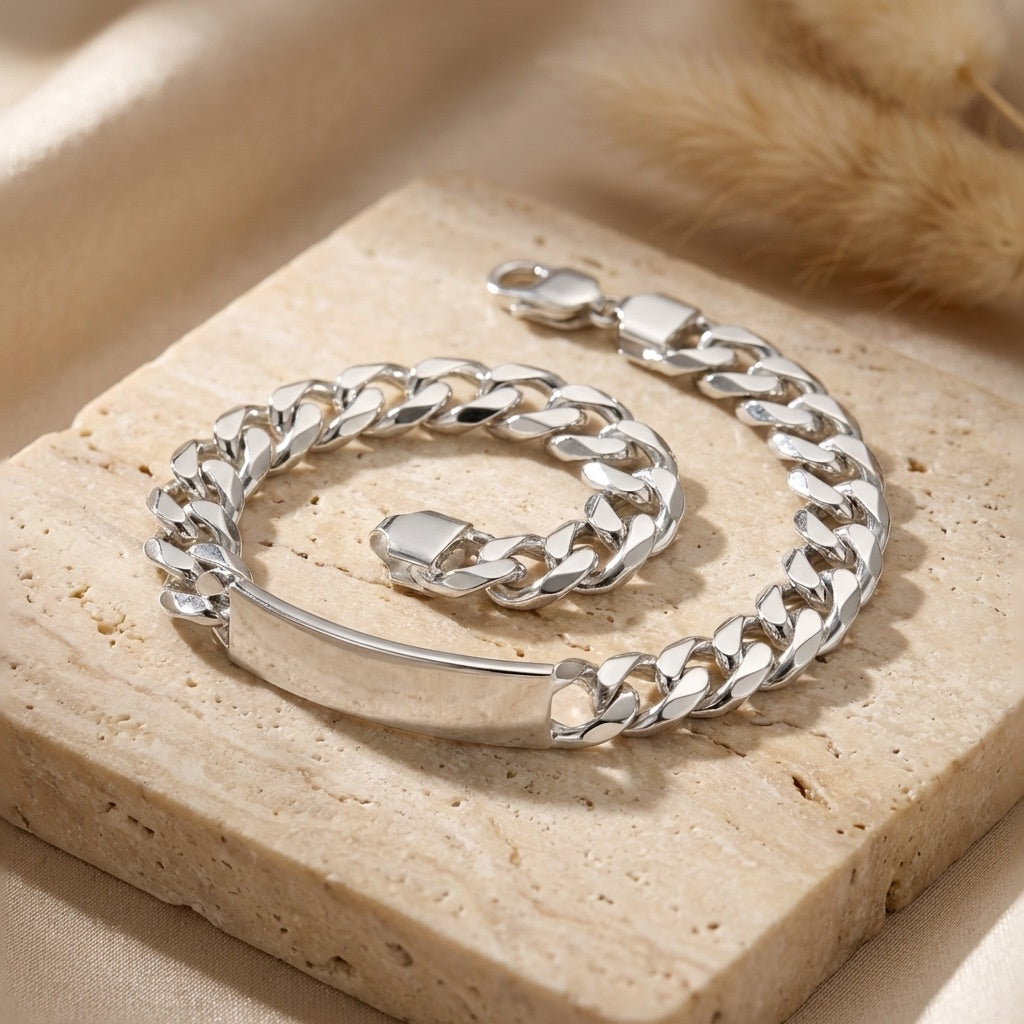 Silver chain bracelet on a beige stone surface