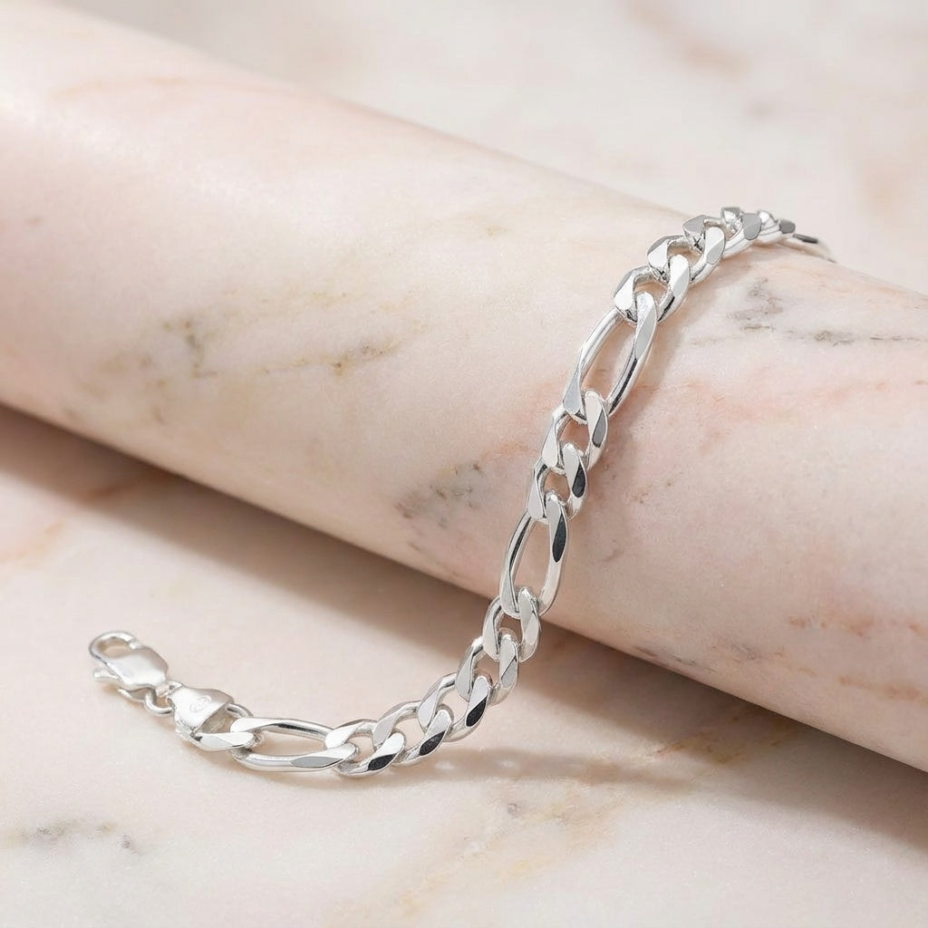 Silver chain bracelet on a marble surface