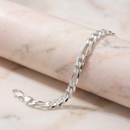 Silver chain bracelet on a marble surface