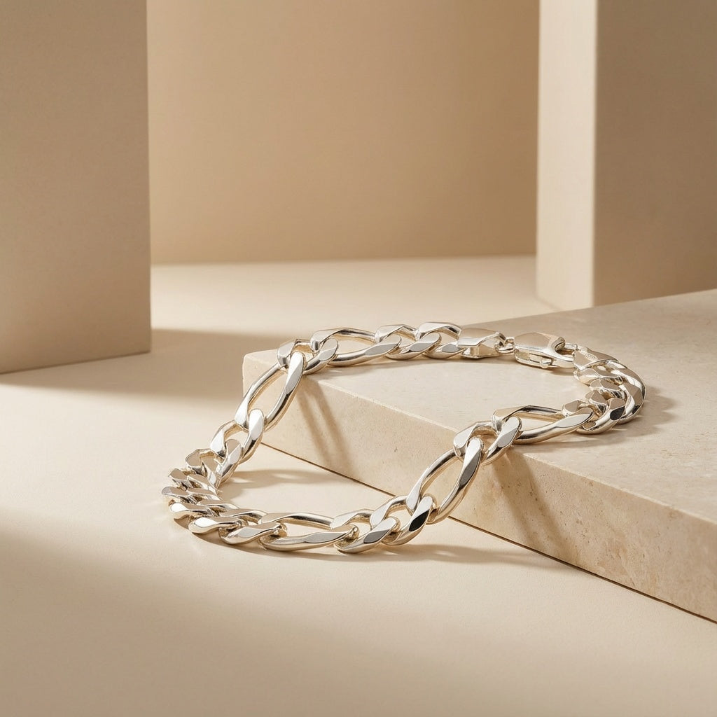 Silver chain bracelet on a beige geometric background