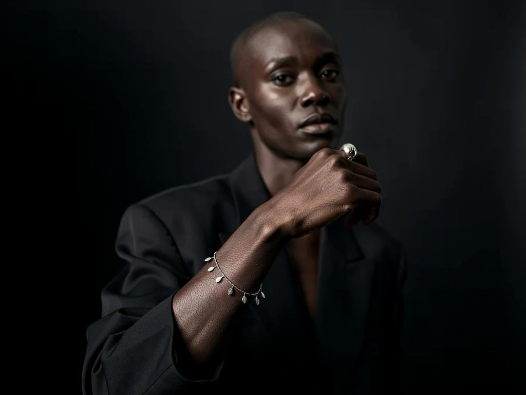 Man wearing a black suit with a dark background