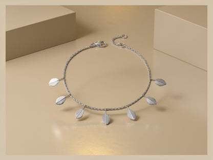 Silver necklace with leaf pendants on a beige background