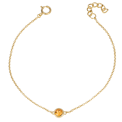Gold bracelet with a round gemstone on a white background