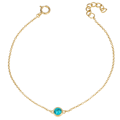 Gold bracelet with a blue gemstone on a white background