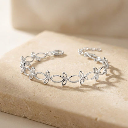 Silver bracelet on a beige stone surface