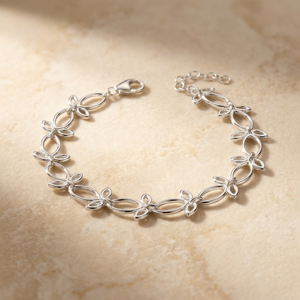 Silver bracelet on a beige stone background
