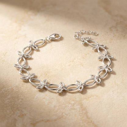 Silver bracelet on a beige stone background
