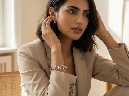 Woman wearing a silver bracelet in a neutral setting