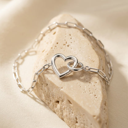 Silver bracelet with heart design on a beige stone