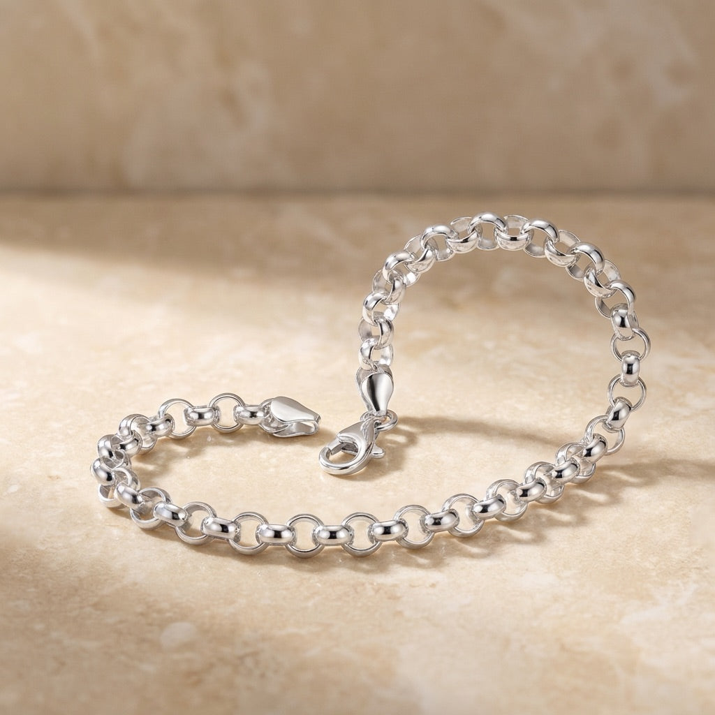 silver Belcher chain bracelet posed on stone tile