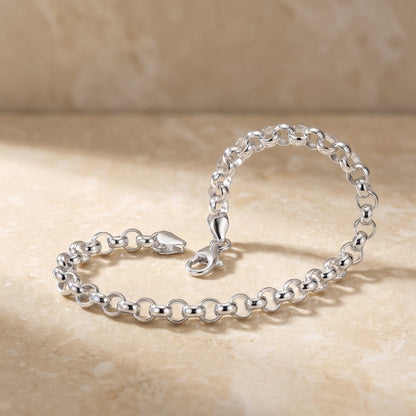 silver Belcher chain bracelet posed on stone tile
