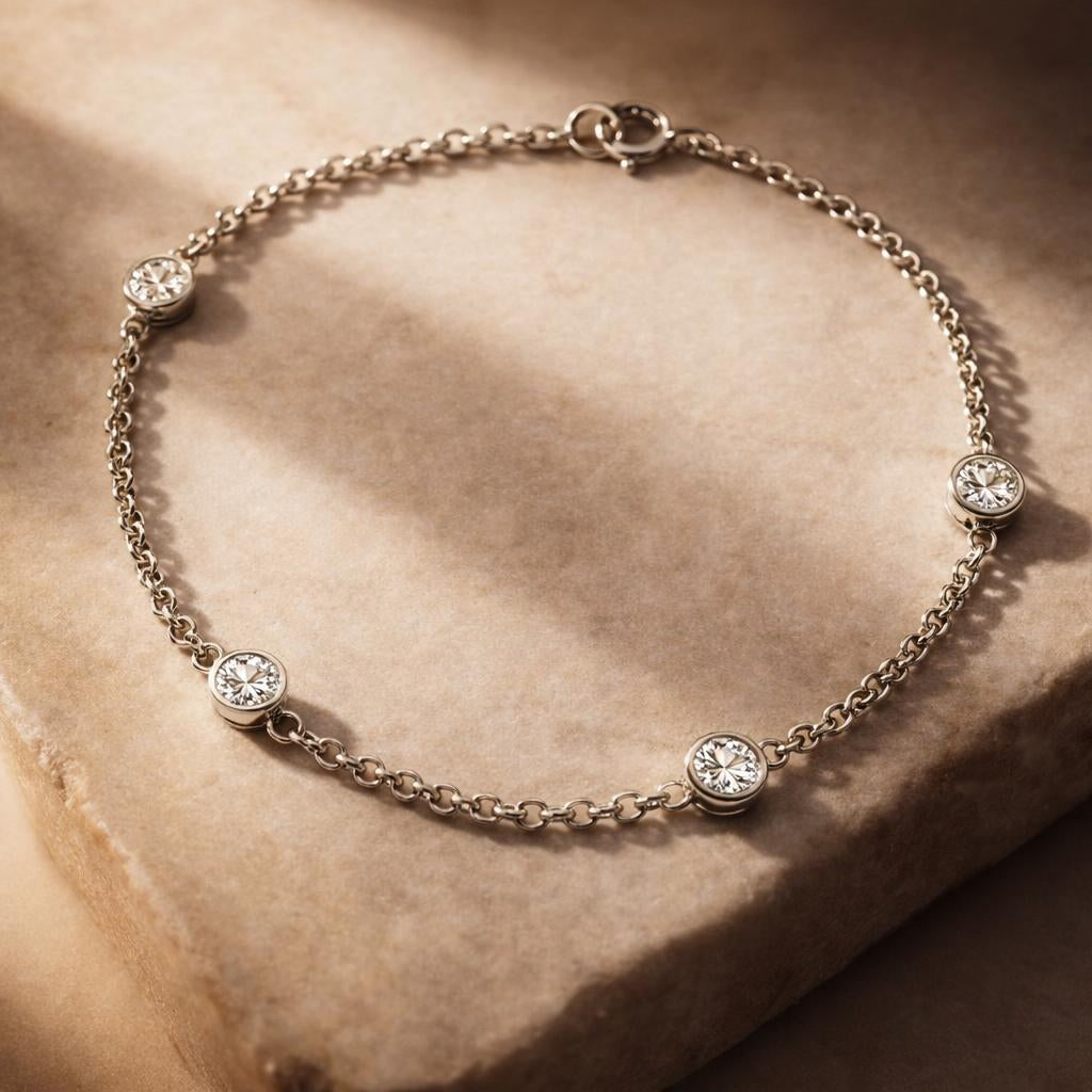 Silver bracelet with small round crystals on a beige stone surface